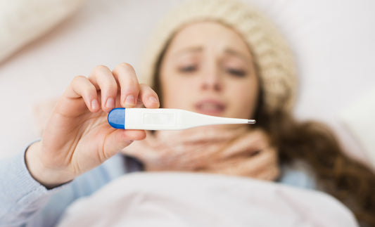 Sick woman with thermometer