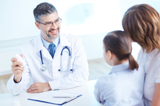 Doctor talking to mom and daughter