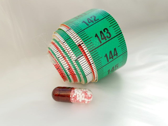 A pill and a tape-measure