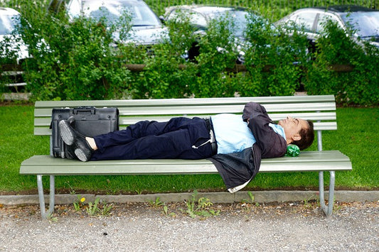 A man slepping on a bench 