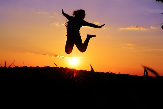 A girl jumping at sunset