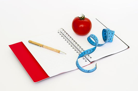 Tape, tomato, pen and notebook