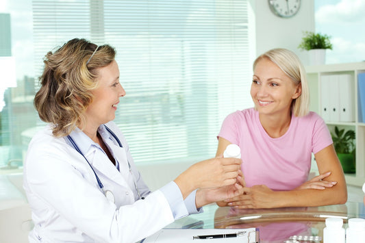 Practitioner prescribing vitamins to patient
