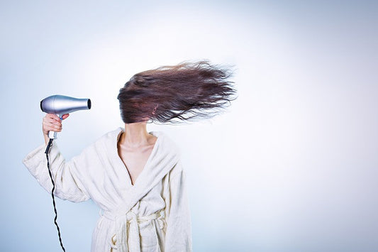 Woman with a hair dryer