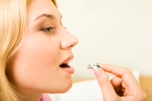 A woman taking a pill
