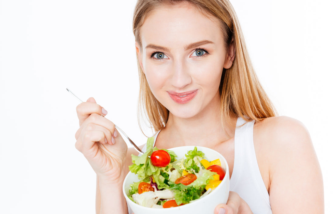 Smiling woman with a plate of salad
