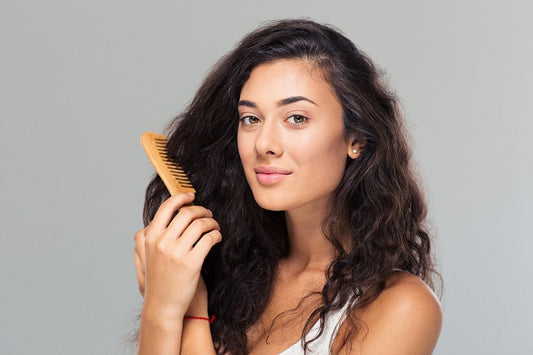 A young woman combing her hair
